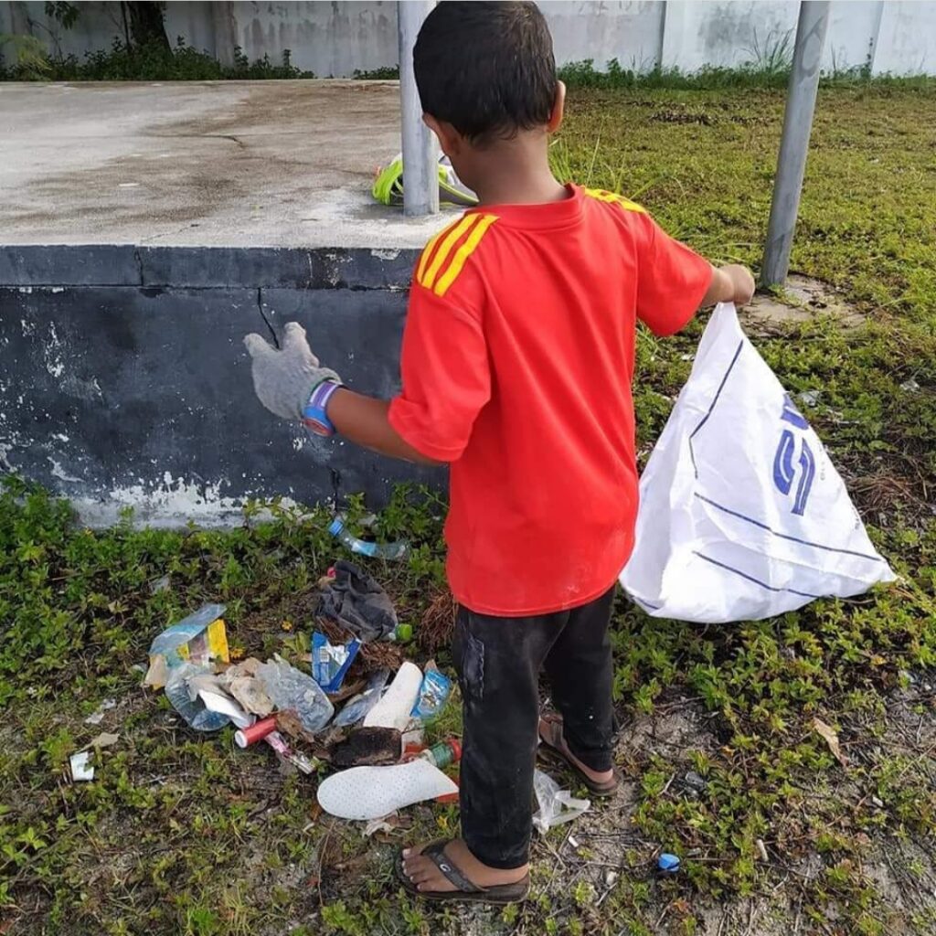 child picking up rubbish